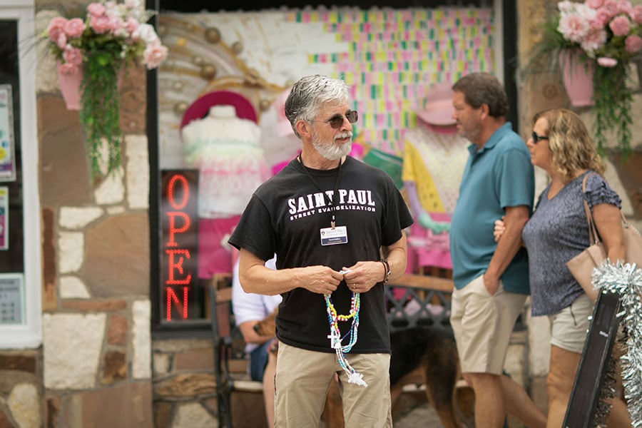 David Rollins, of the Saint Paul Street Evangelization ministry talks with visitors to the Granbury Town Square, Saturday, May 27, 2023.